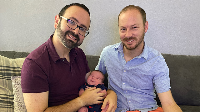 Two dads with their son