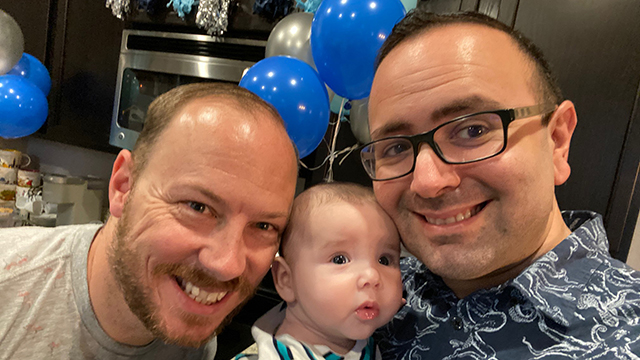 Two dads with their son