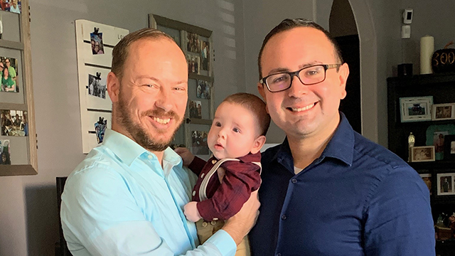 Two dads with their son